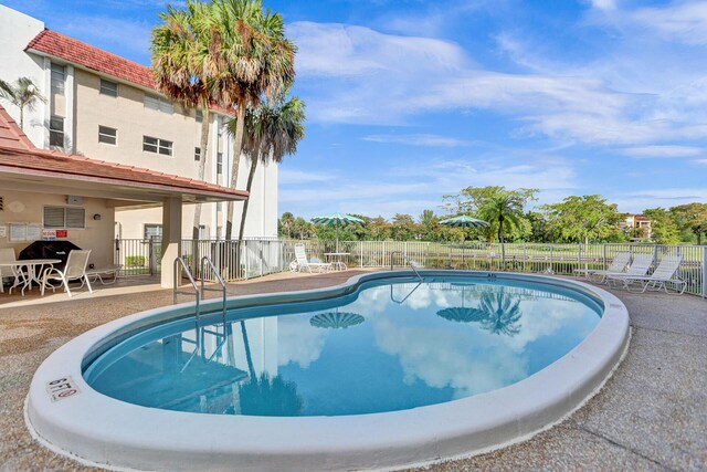 3601 Inverrary Dr Unit 102, Lauderhill, FL 33319 - community pool featuring a patio