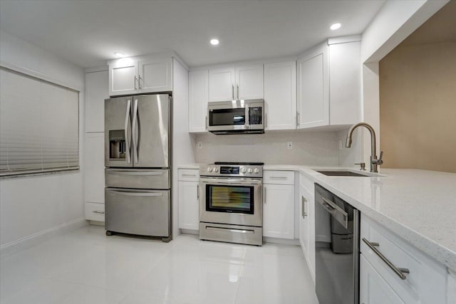 3601 Inverrary Dr Unit 102, Lauderhill, FL 33319 - kitchen featuring stainless steel appliances, a sink, white cabinets, light stone countertops, and recessed lighting
