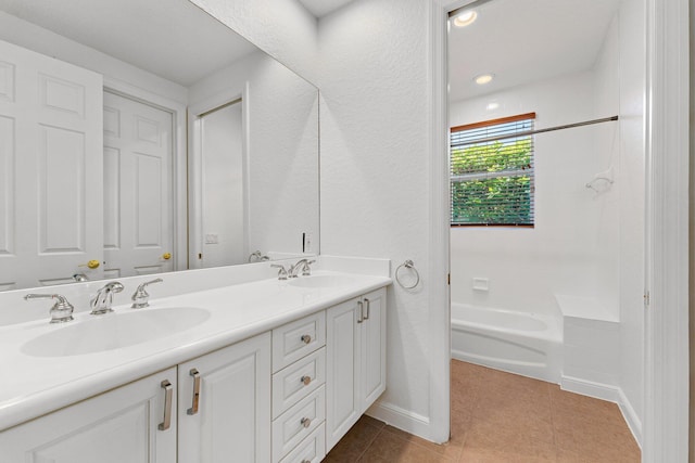 bathroom featuring a tub, tile patterned floors, and vanity