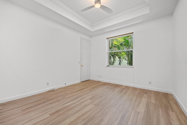 unfurnished room with a raised ceiling, ceiling fan, a textured ceiling, and light hardwood / wood-style flooring