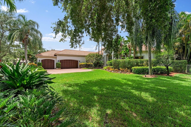 view of front of home featuring a garage and a front yard