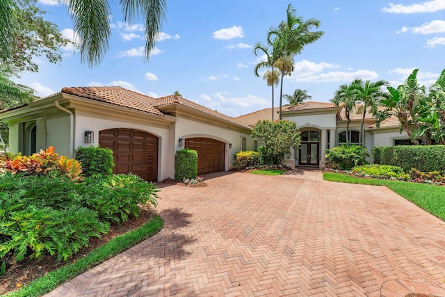 mediterranean / spanish home featuring a garage