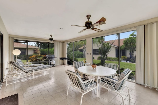 sunroom / solarium featuring ceiling fan and a wealth of natural light