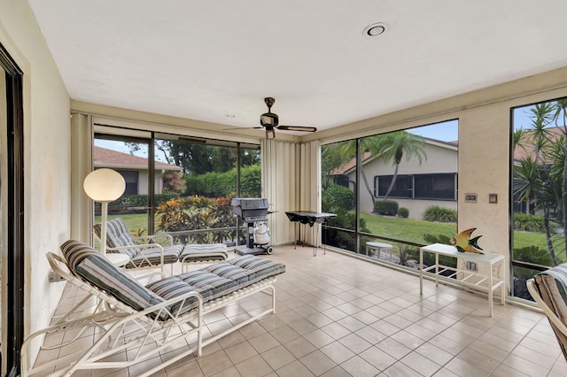 sunroom featuring ceiling fan