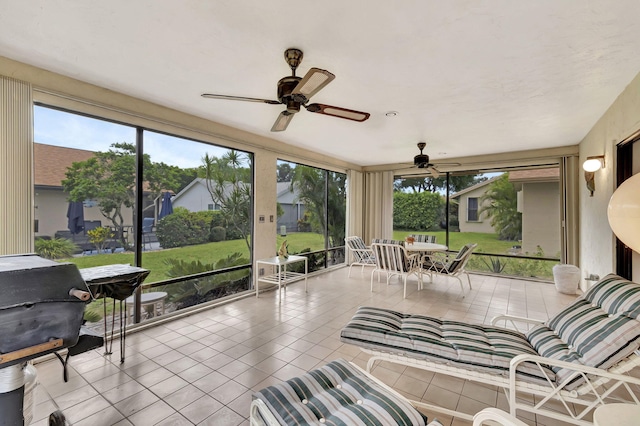 sunroom featuring ceiling fan