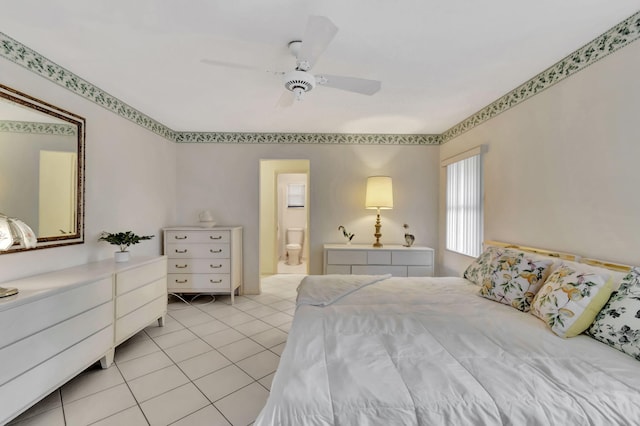 bedroom with ensuite bath, light tile patterned flooring, and ceiling fan