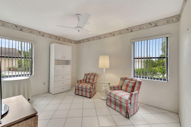 sitting room featuring light tile patterned floors, plenty of natural light, and ceiling fan