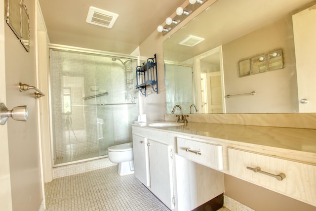 bathroom featuring vanity, an enclosed shower, tile patterned flooring, and toilet