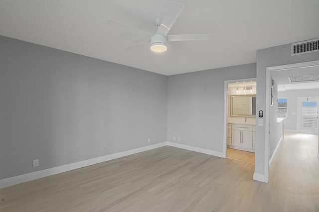 spare room featuring ceiling fan and light wood-type flooring