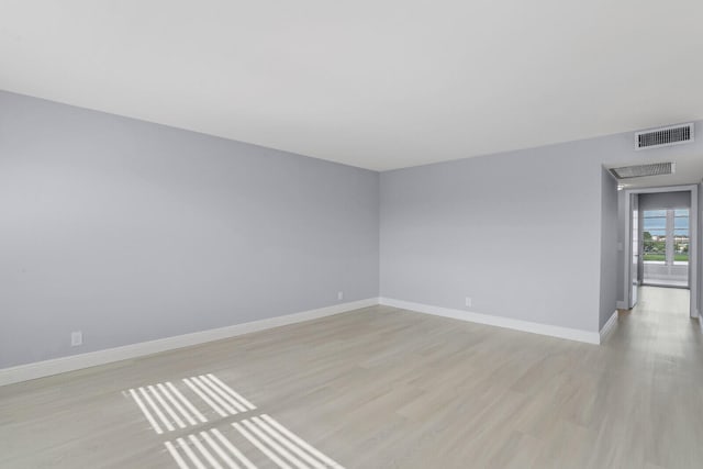 spare room with light hardwood / wood-style flooring