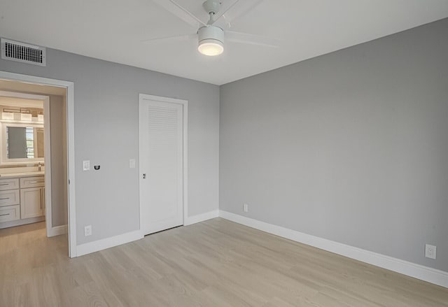 unfurnished bedroom featuring light hardwood / wood-style floors, ceiling fan, and a closet