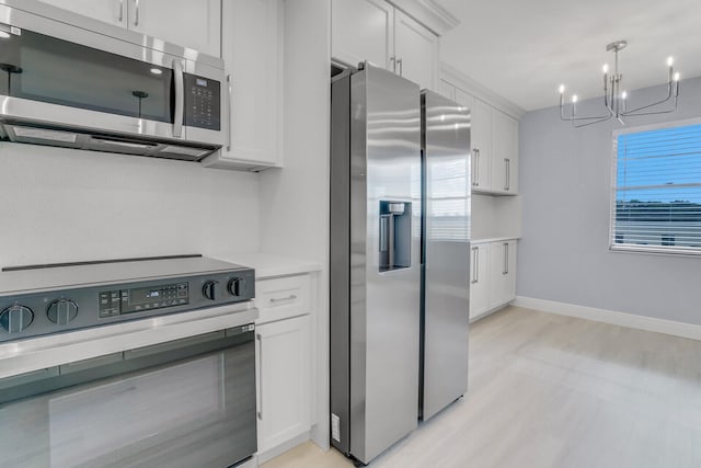 kitchen with light hardwood / wood-style flooring, white cabinetry, a chandelier, and stainless steel appliances