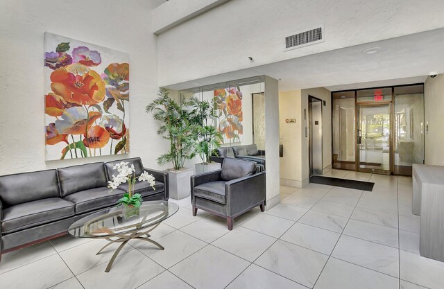 dining area with a textured ceiling and light tile patterned floors