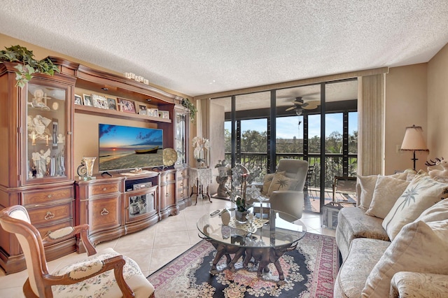 tiled living room featuring a textured ceiling, floor to ceiling windows, and ceiling fan