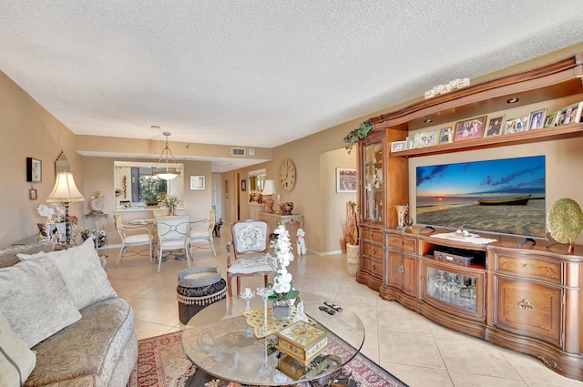 tiled living room featuring a textured ceiling