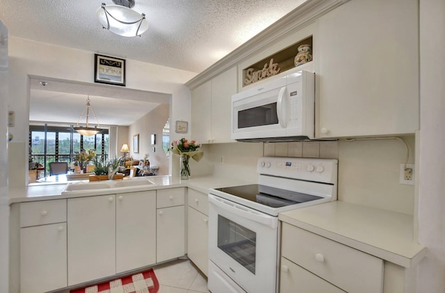 kitchen with sink, white cabinets, light tile patterned floors, white appliances, and a textured ceiling