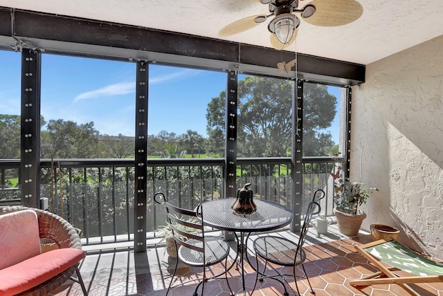 sunroom featuring a wealth of natural light and ceiling fan