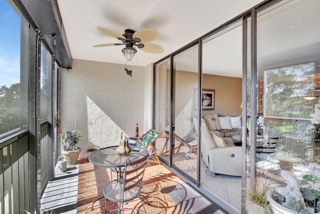 sunroom / solarium featuring ceiling fan