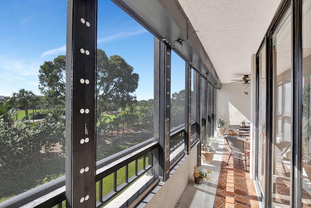 unfurnished sunroom featuring ceiling fan and french doors