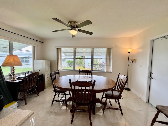 tiled dining space with ceiling fan