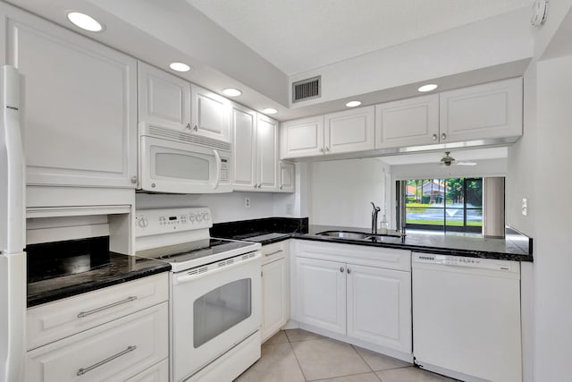 kitchen featuring white cabinetry, sink, light tile patterned flooring, and white appliances