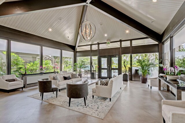 sunroom featuring vaulted ceiling, french doors, and a chandelier