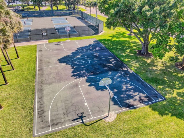 view of sport court featuring a lawn