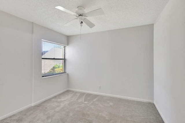 spare room featuring carpet, a textured ceiling, and ceiling fan