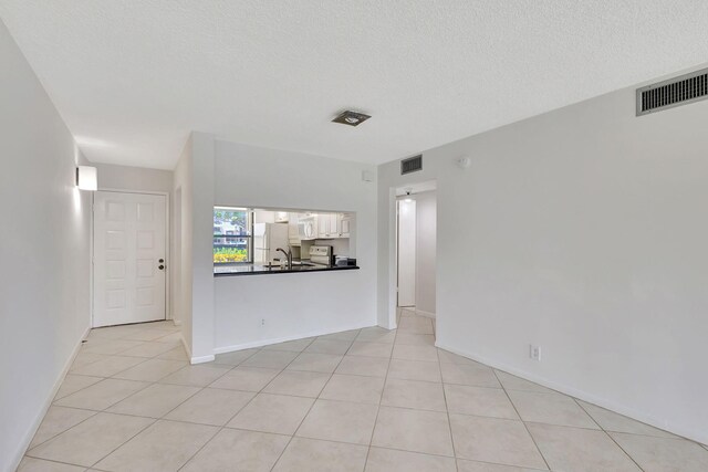 unfurnished bedroom with a closet, a textured ceiling, ceiling fan, and light colored carpet