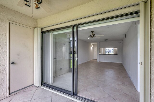 interior space with ceiling fan