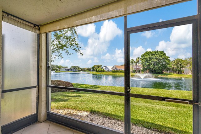 unfurnished sunroom with a water view