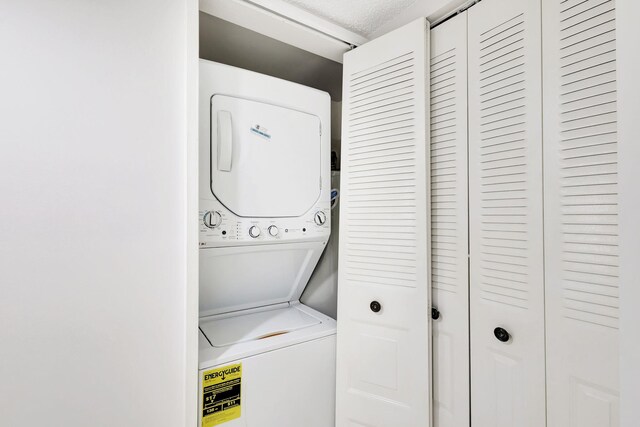 laundry room with stacked washer / dryer