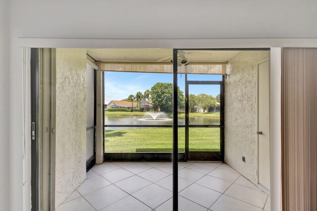 unfurnished sunroom featuring a water view