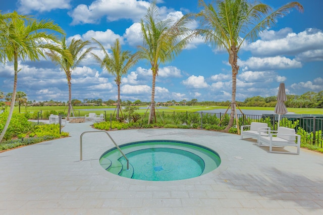 view of pool with an in ground hot tub and a patio