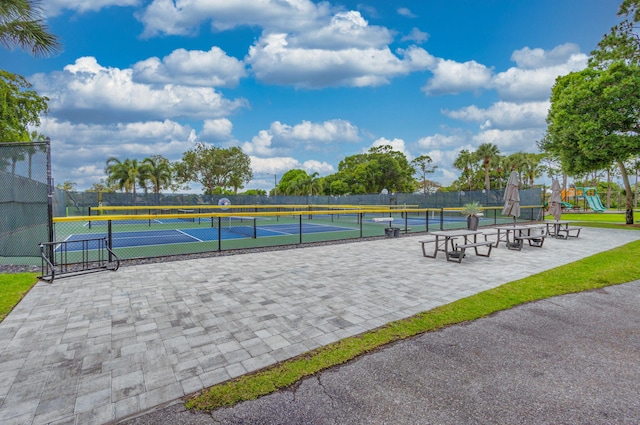 surrounding community with tennis court and a playground