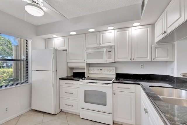 kitchen featuring white cabinetry, a healthy amount of sunlight, and white appliances