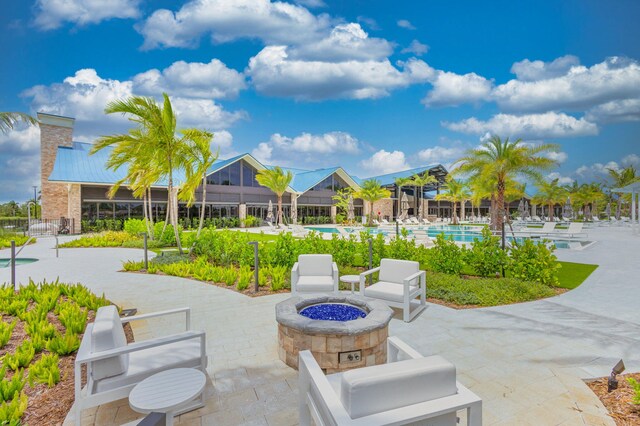 view of patio / terrace with a community pool and an outdoor fire pit