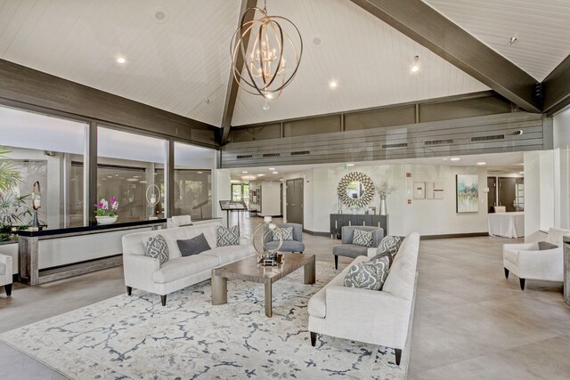 living room featuring an inviting chandelier and high vaulted ceiling