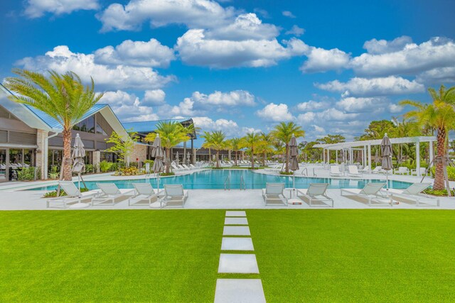 view of swimming pool with a lawn and a patio area