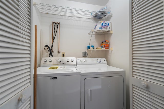 clothes washing area featuring washer and dryer