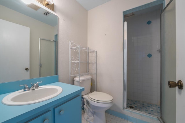 bathroom featuring vanity, walk in shower, tile patterned flooring, and toilet