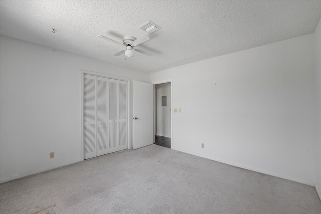 unfurnished bedroom featuring a textured ceiling, ceiling fan, carpet flooring, and a closet