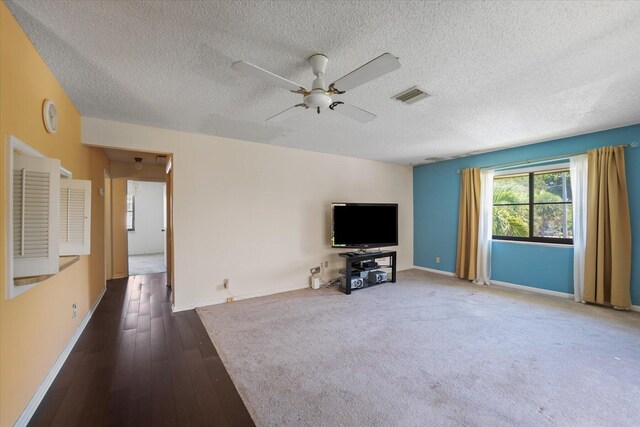 unfurnished living room featuring a textured ceiling, wood-type flooring, and ceiling fan