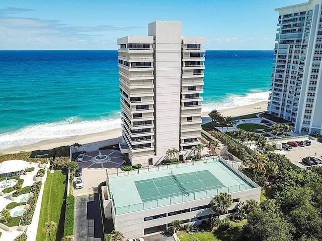 birds eye view of property with a view of the beach and a water view