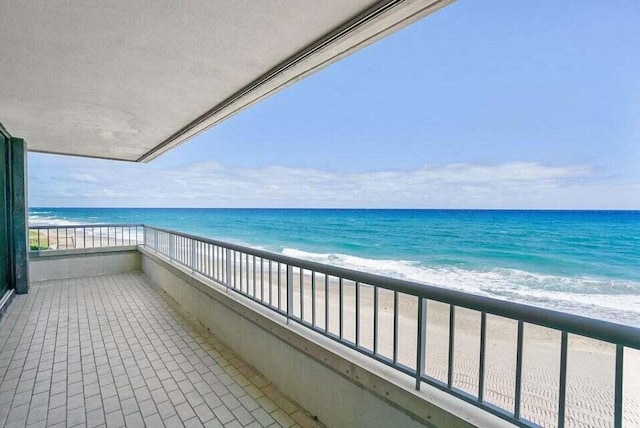 balcony with a view of the beach and a water view