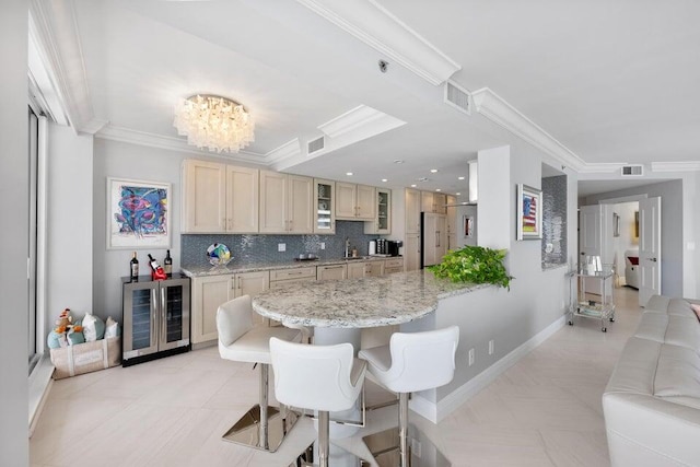 kitchen featuring white fridge, decorative backsplash, crown molding, an inviting chandelier, and light tile patterned floors