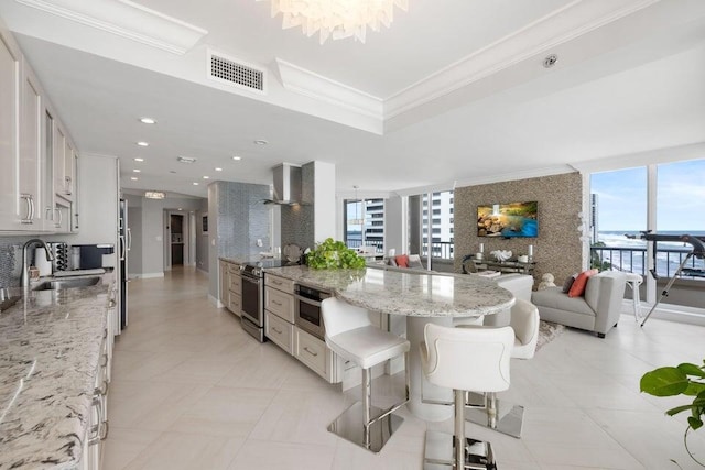 kitchen featuring sink, a breakfast bar area, decorative backsplash, and white cabinets