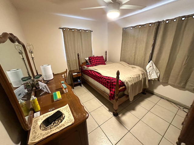 tiled bedroom featuring ceiling fan