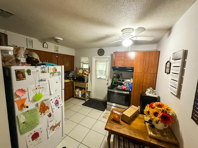 kitchen featuring ceiling fan, stainless steel appliances, a textured ceiling, and light tile patterned floors