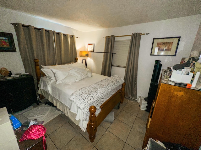 bedroom featuring a textured ceiling and light tile patterned floors